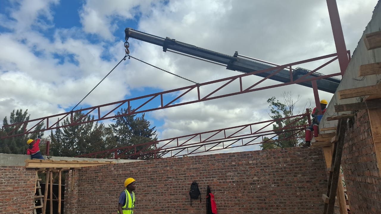 Steel roof truss being lifted